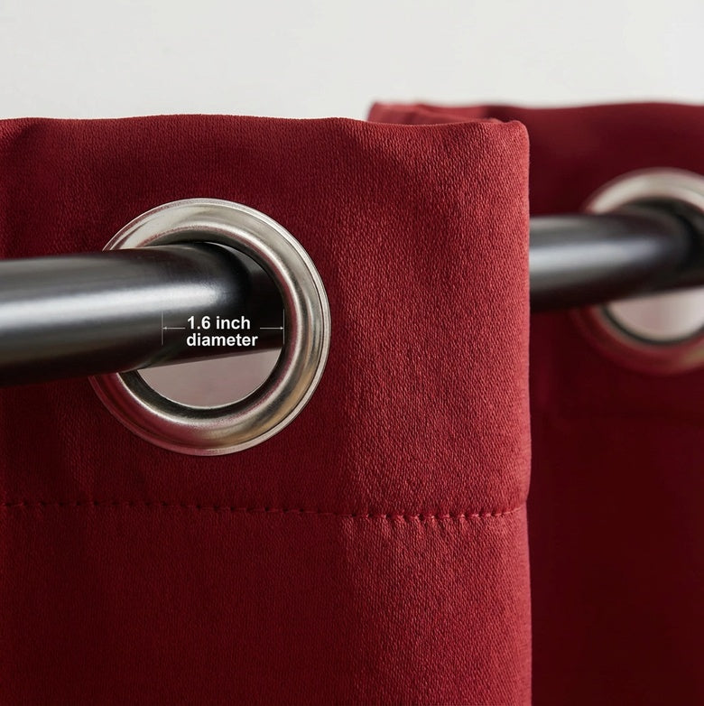 Red blockout curtain close-up showing grommet top design