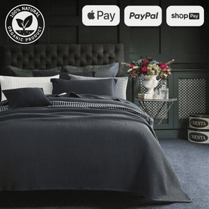 Luxurious bedroom with dark grey bedding set, floral arrangement, and organic product certification. Payment options: Apple Pay, PayPal, Shop Pay.