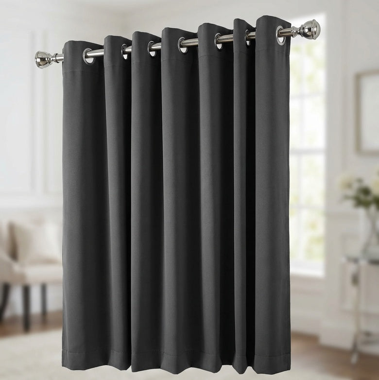 Black blockout curtains installed in a living room reducing light and noise