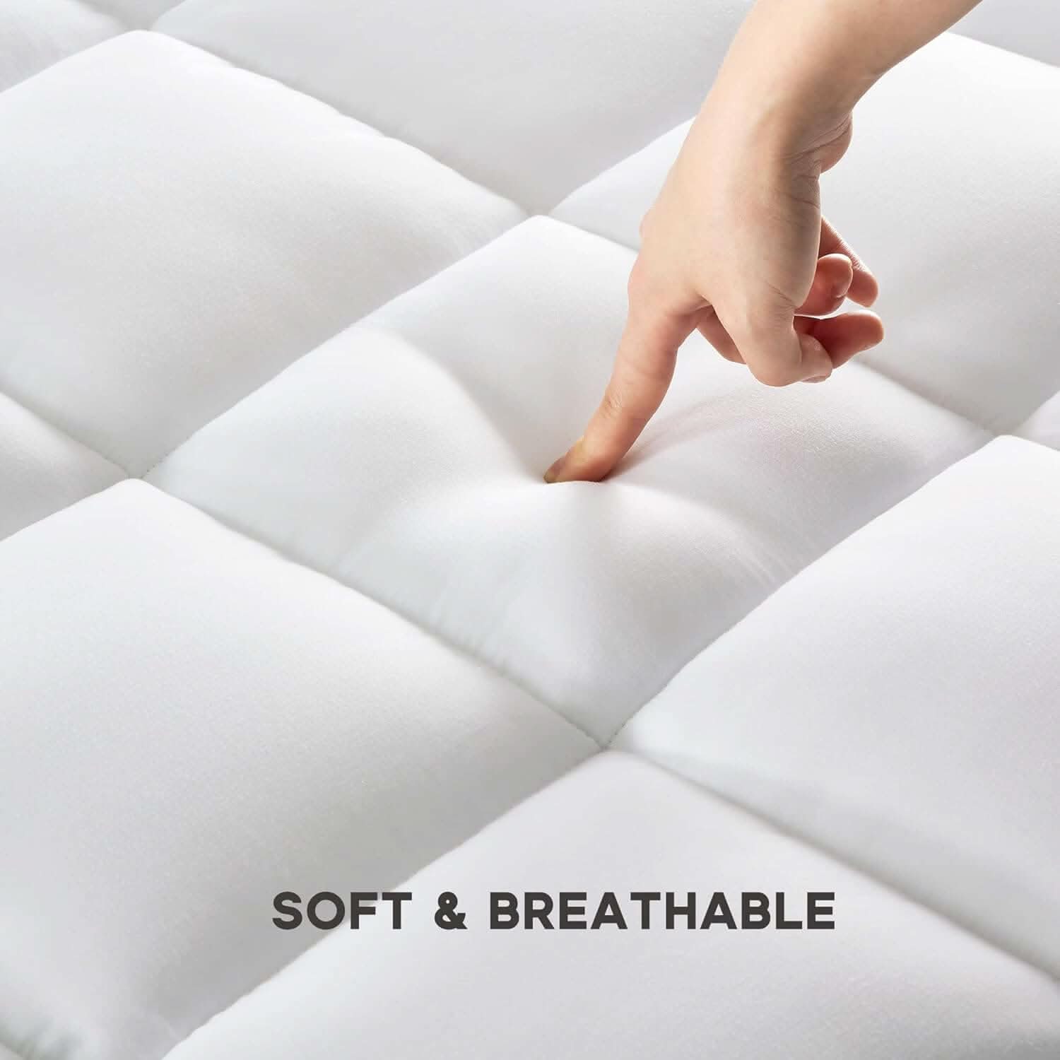 Close-up of a hand pressing into a soft, breathable quilted mattress topper, showcasing its plush and cushioned texture