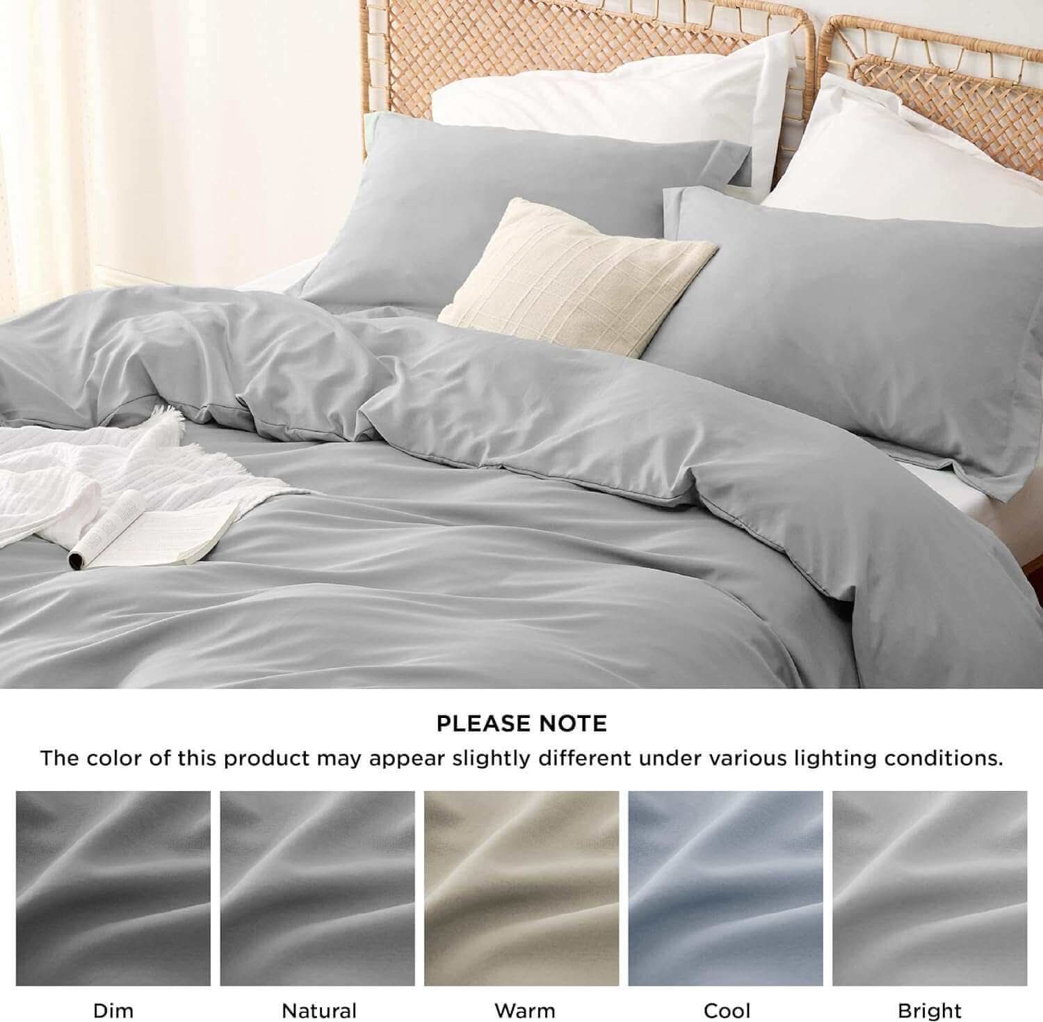 Luxurious gray bedding set on a bed with pillows, featuring color variations under different lighting conditions.