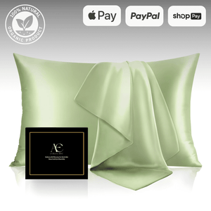 Elegant sage green silk pillowcase set with a matching silk cloth, accompanied by a black gift box, highlighting its luxurious and smooth texture.