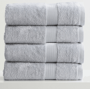Stack of four folded gray towels with textured stripes, neatly arranged on a white surface.