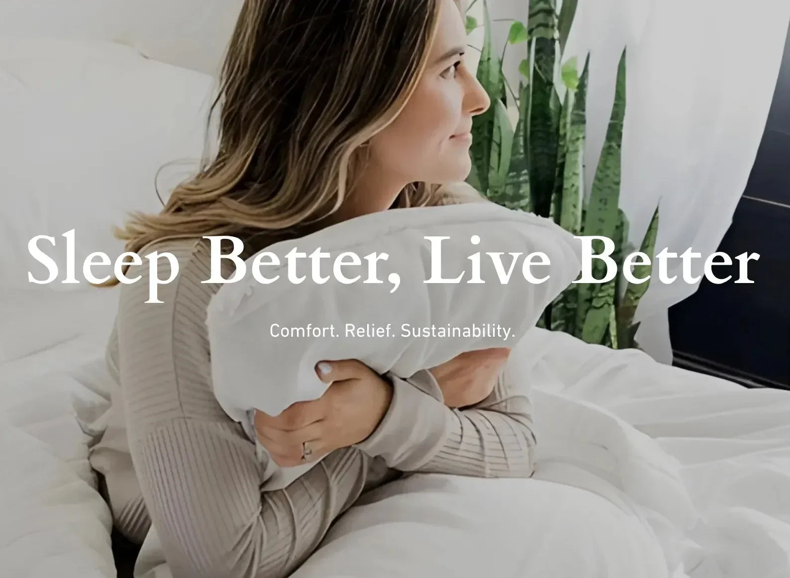 Woman holding a pillow in a cozy bedroom setting.