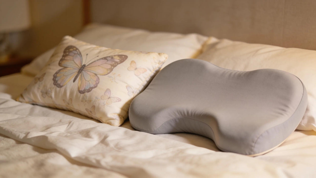 Butterfly and contour pillows on a cozy bed highlighting their designs for side sleepers