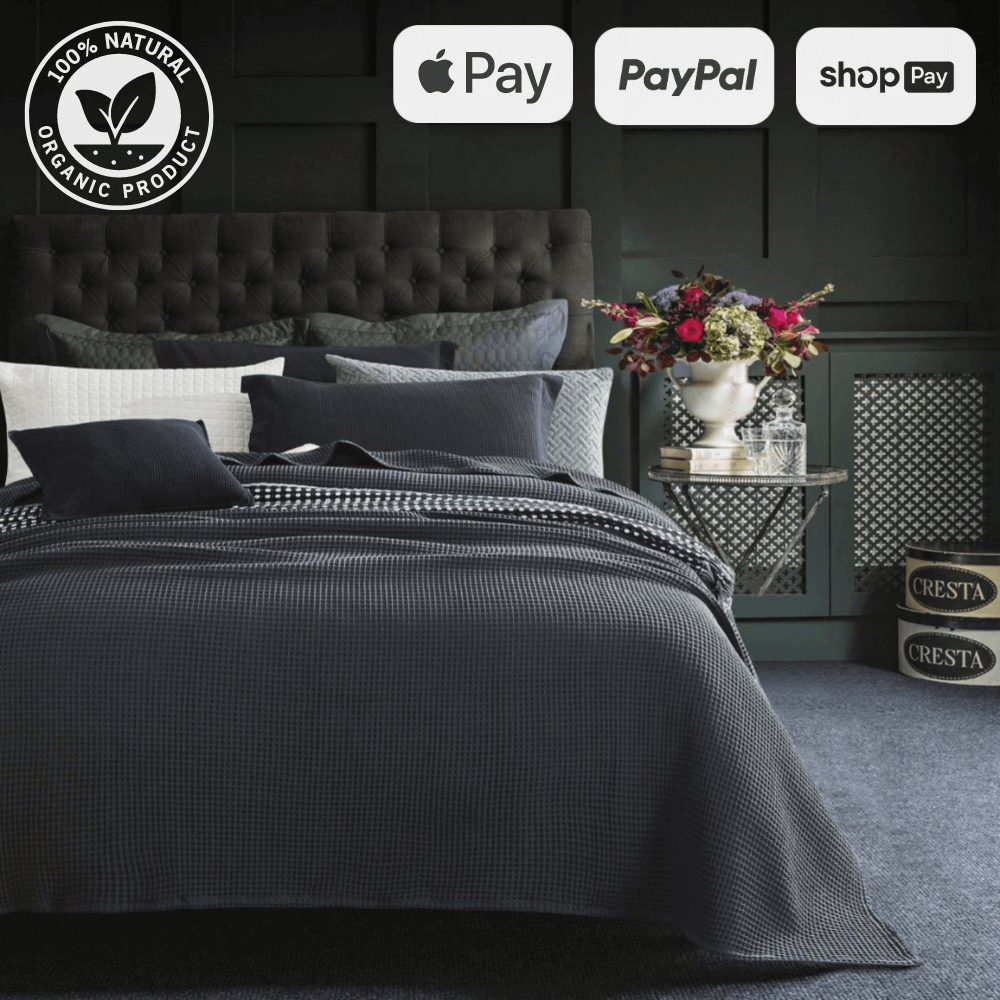 Luxurious bedroom with dark grey bedding set, floral arrangement, and organic product certification. Payment options: Apple Pay, PayPal, Shop Pay.