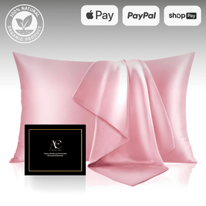 Elegant pink silk pillowcase set with a matching silk cloth, accompanied by a black gift box, highlighting its luxurious and smooth texture