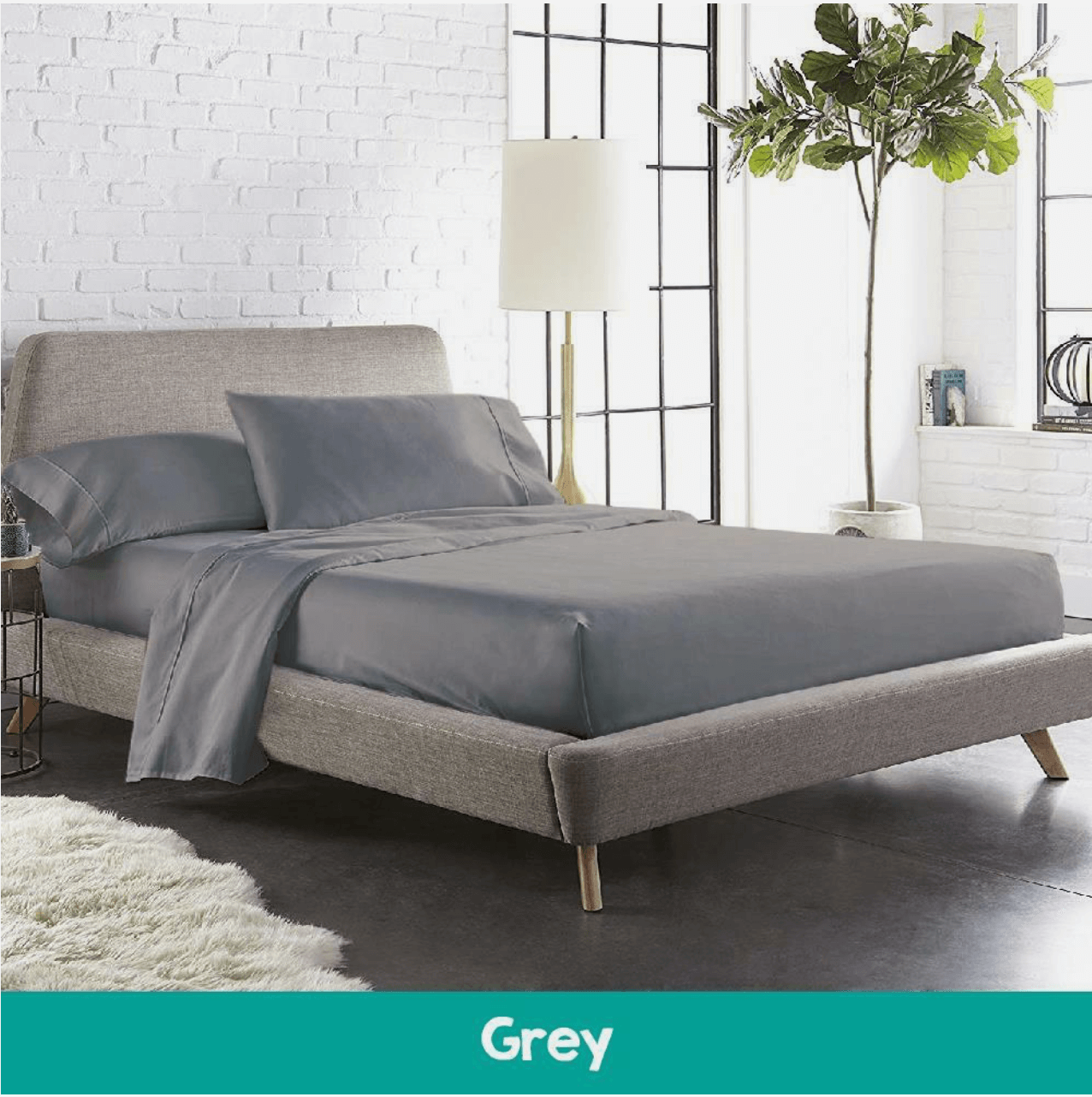 Stylish bedroom featuring a bed with dark gray cotton sheets and a matching quilted mattress topper, creating a modern and cozy sleep environment.