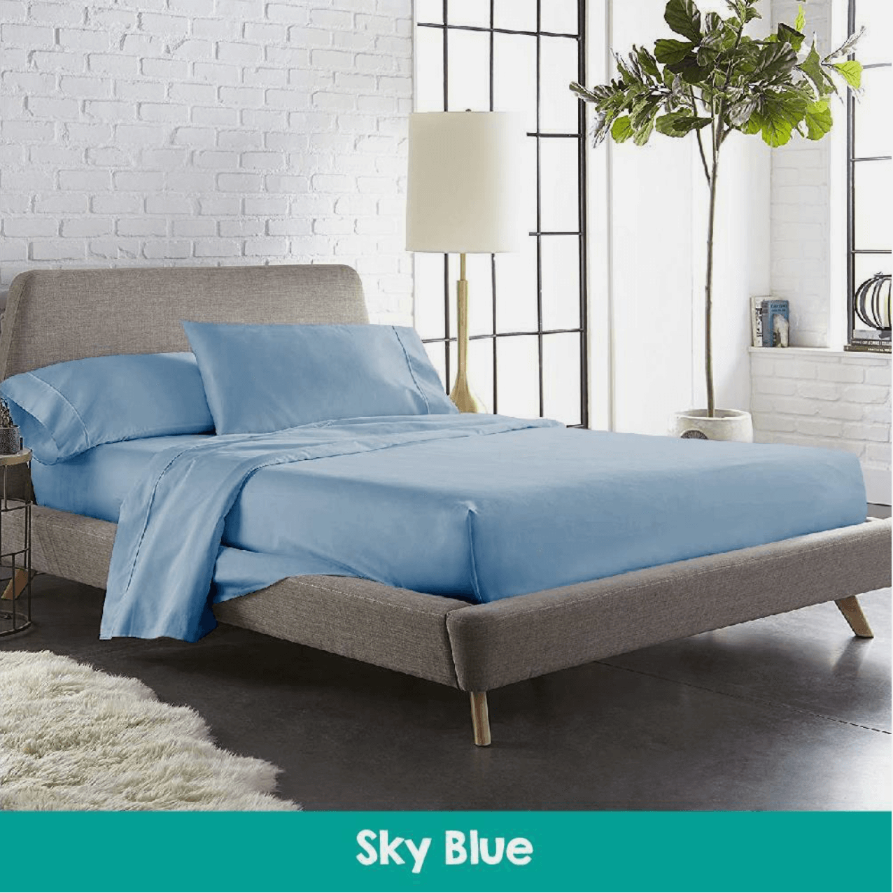 Modern bedroom featuring a bed with sky blue cotton sheets and a matching quilted mattress topper, creating a cool and relaxing sleep environment.