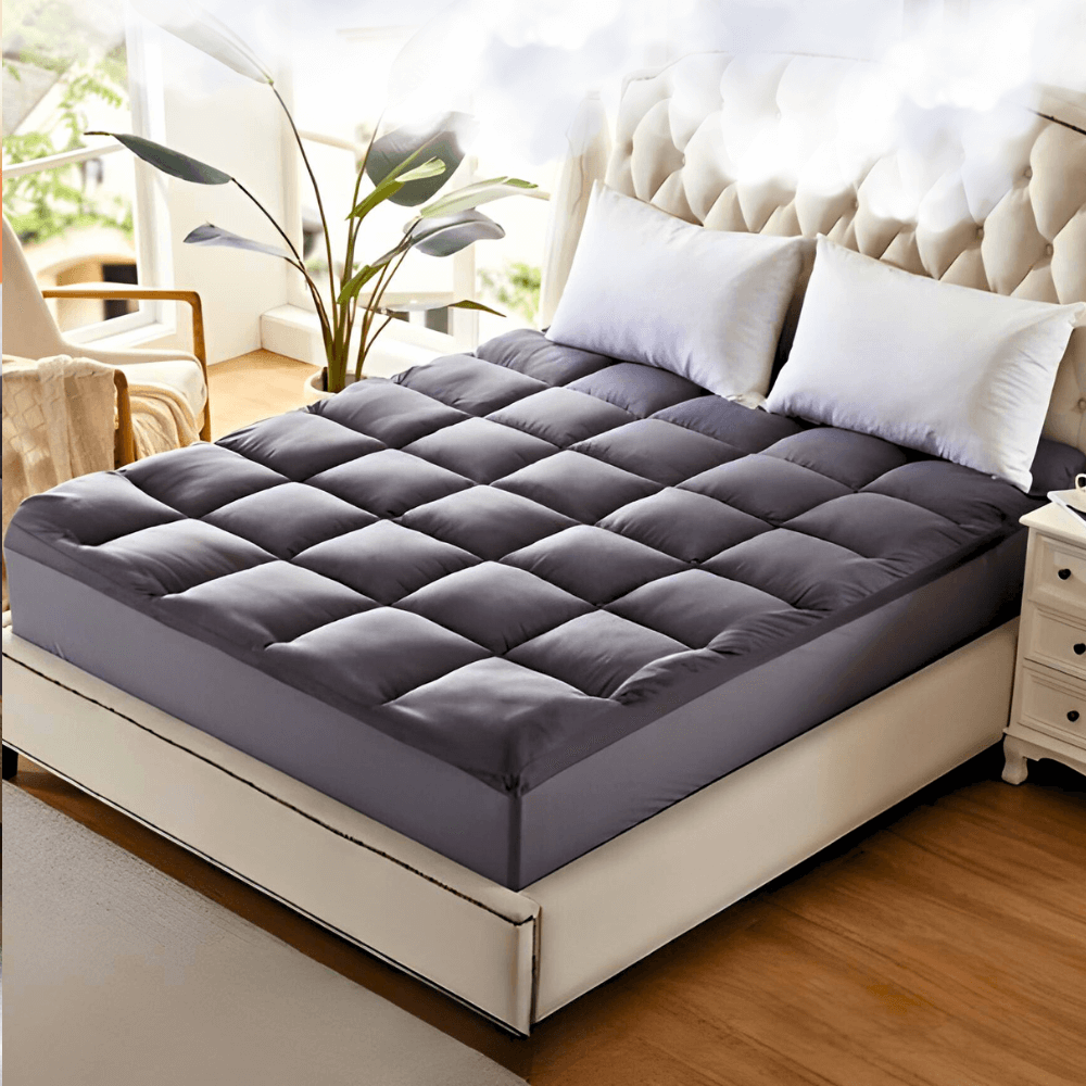 Elegant bedroom with a plush dark gray quilted mattress topper on a large bed, adding extra comfort and style to the space.
